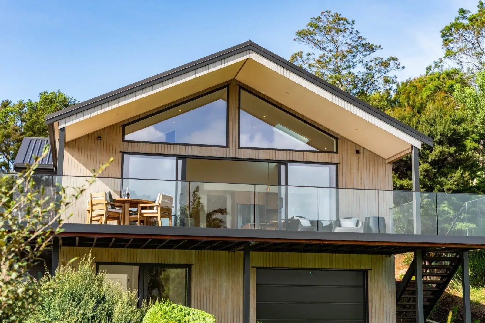 Frameless glass balustrade on the upper deck of a cedar home in Mangawhai, installed by TK Glass NZ