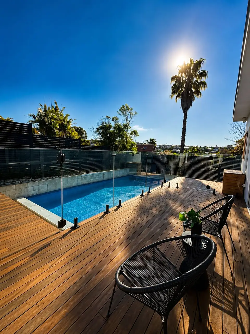 Frameless glass pool fence on a timber deck