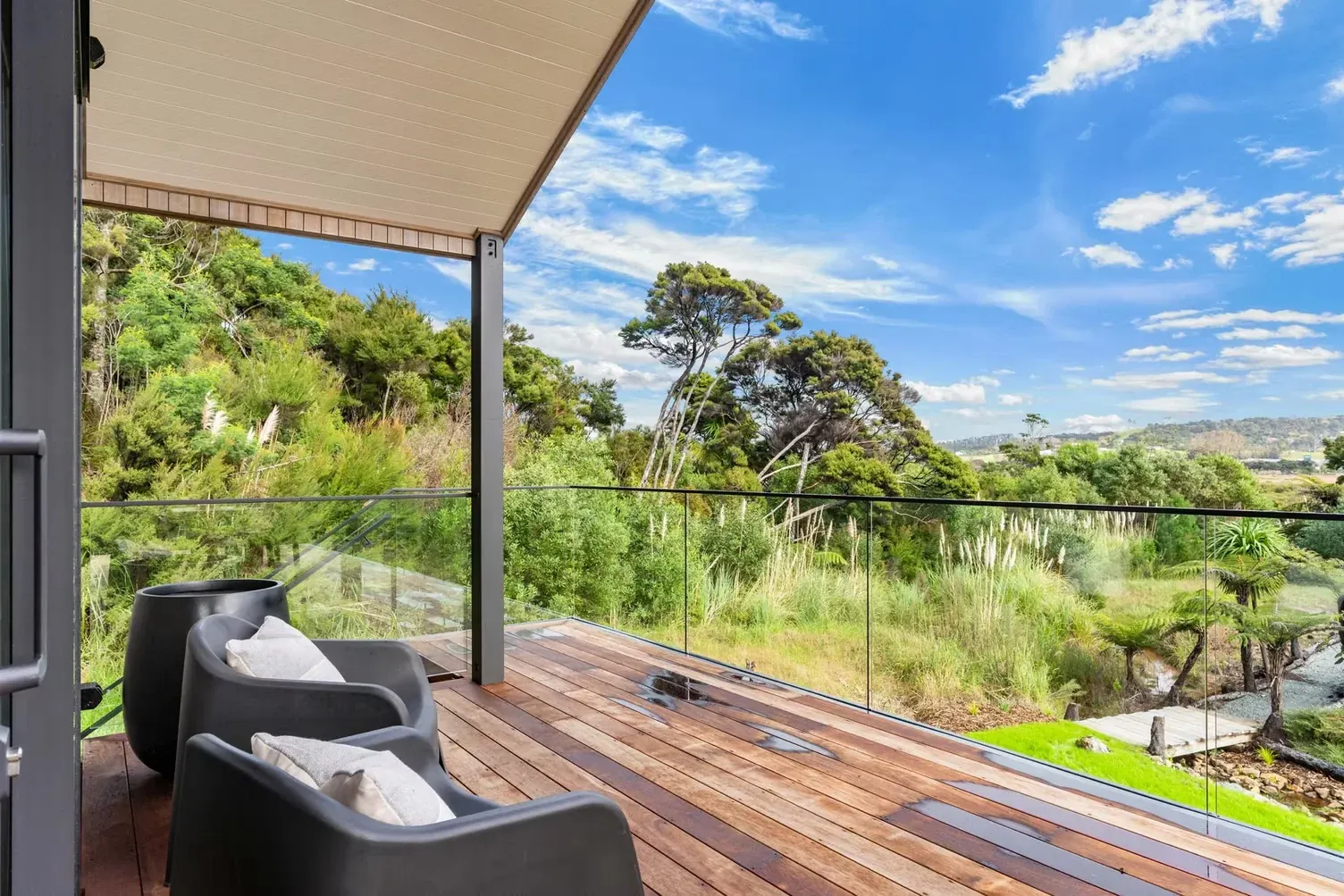 Frameless glass balustrade looking over native bush by TK Glass NZ